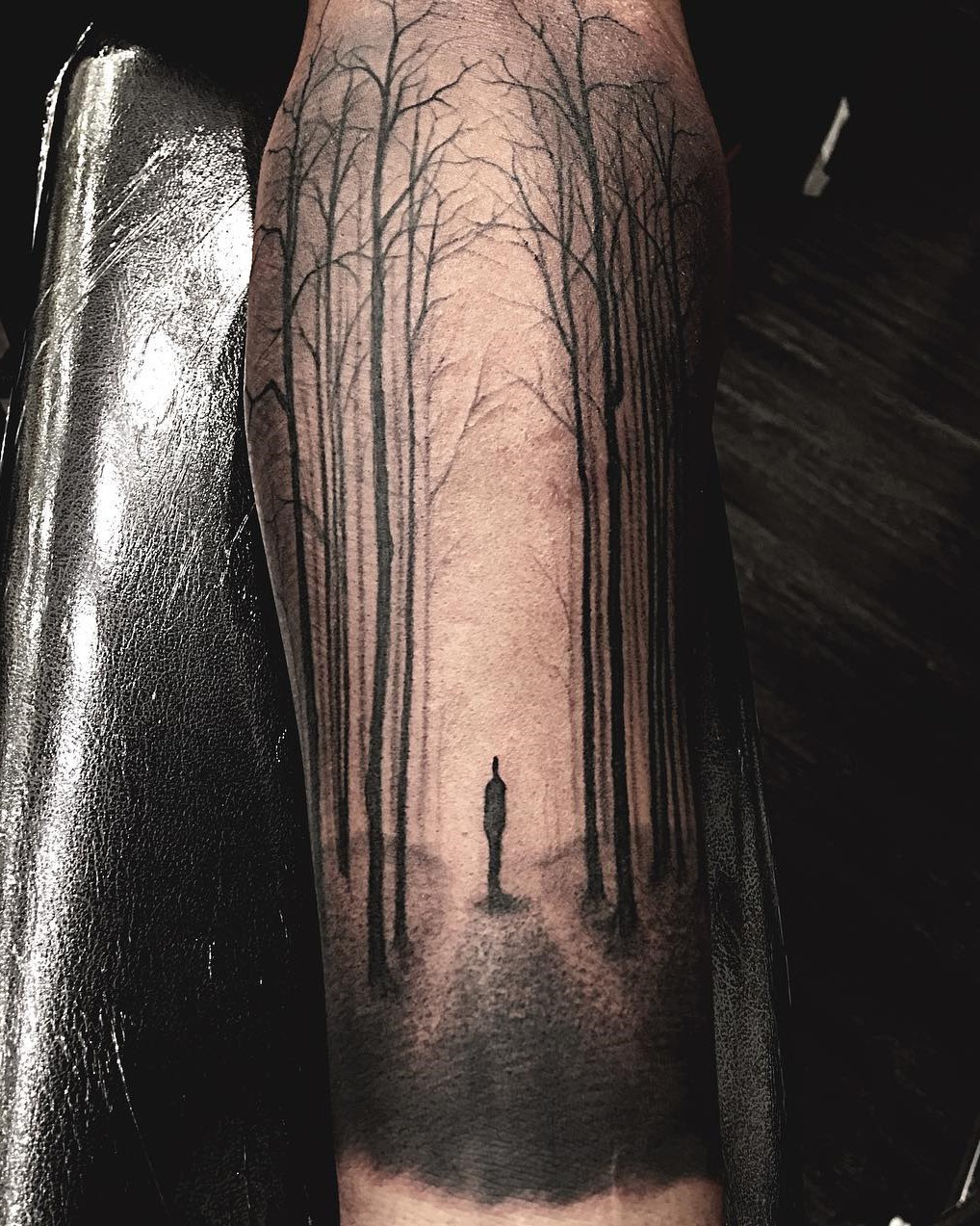 Shadow of a Person standing in the light of a forest black and grey tattoo done by Tattoo Artist Alan Lott at Sacred Mandala Studio in Durham, NC.